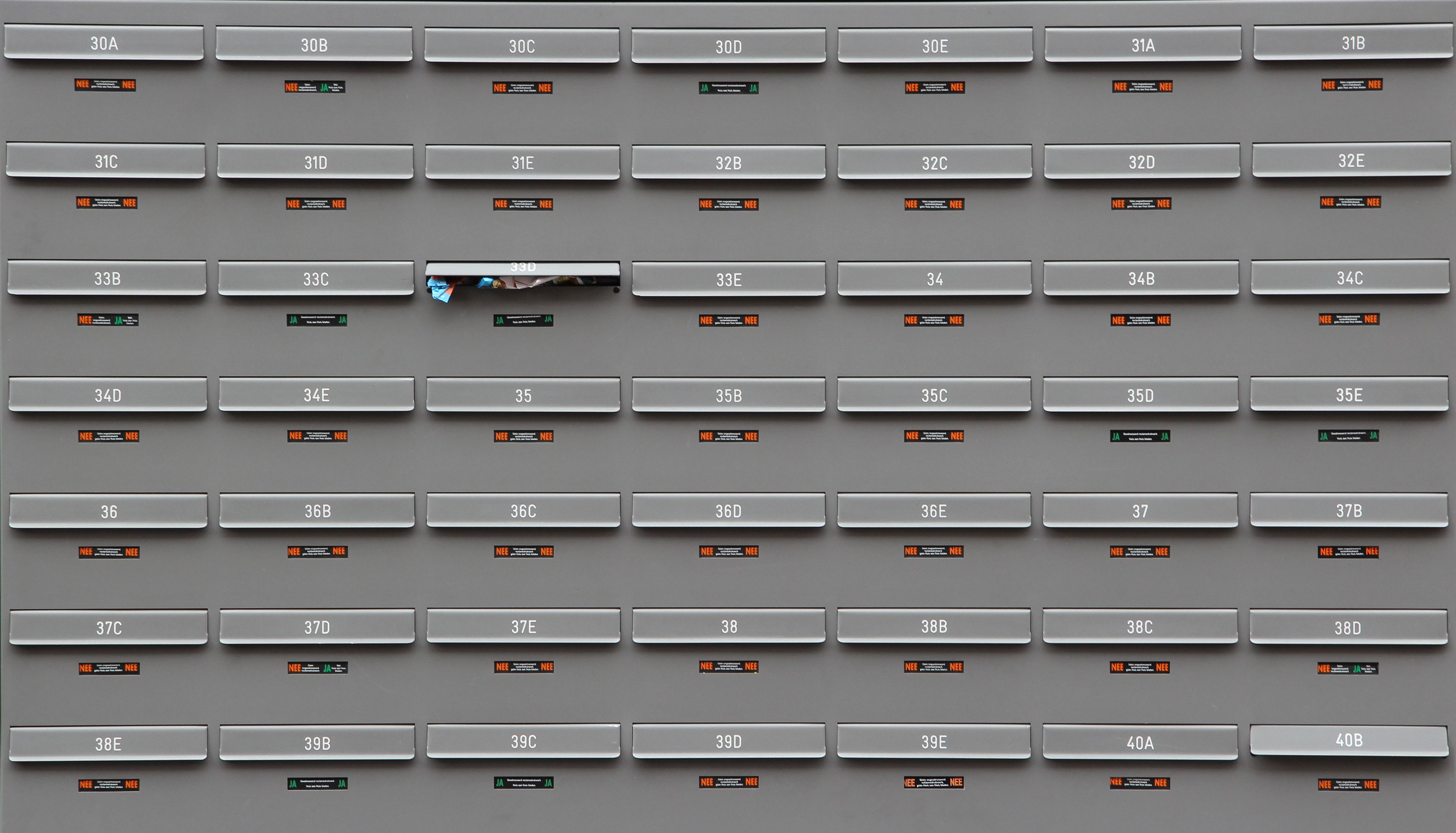 A grid of grey mailboxes with number labels showing an organized system.
