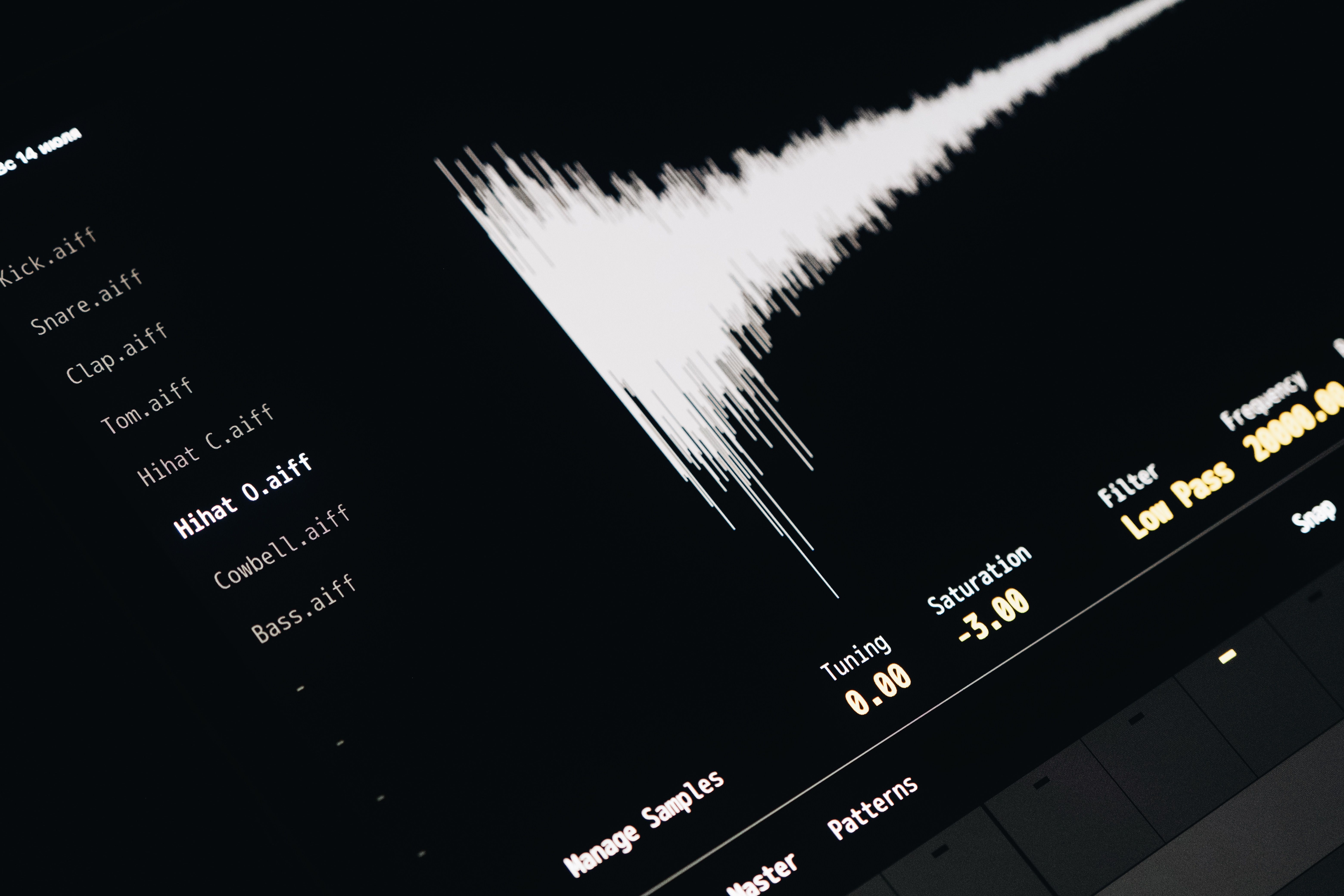 Close-up of a digital audio editing interface displaying sound waves and file names.